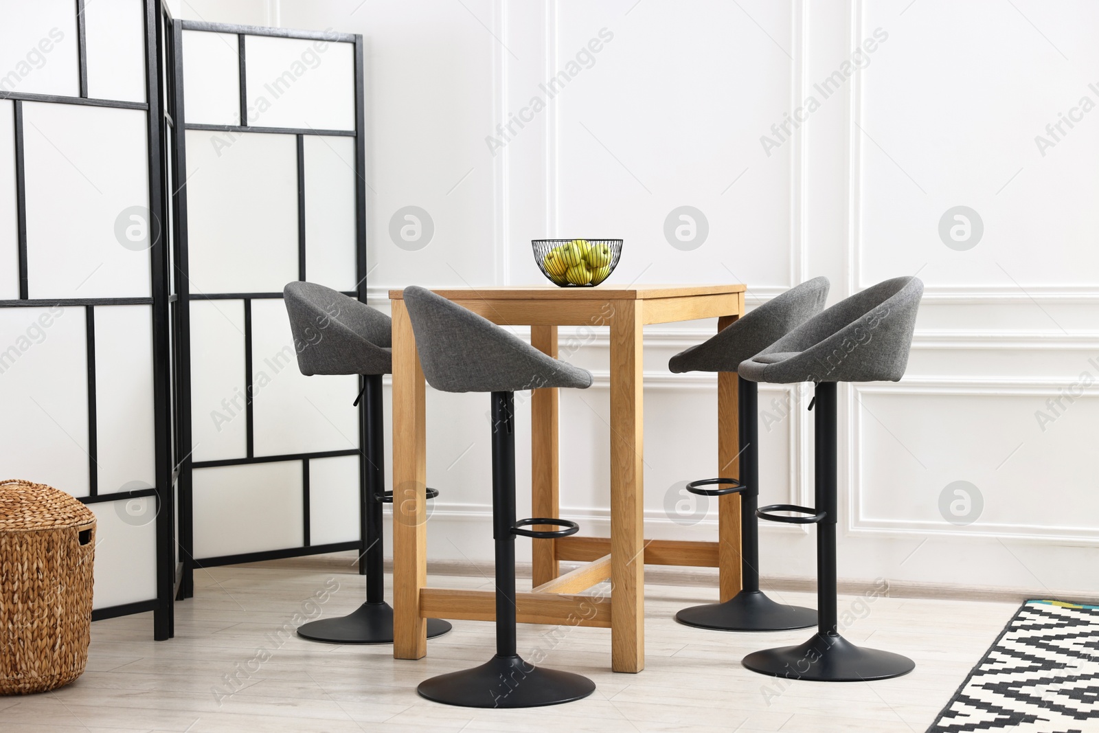 Photo of Bar stools near table in stylish room