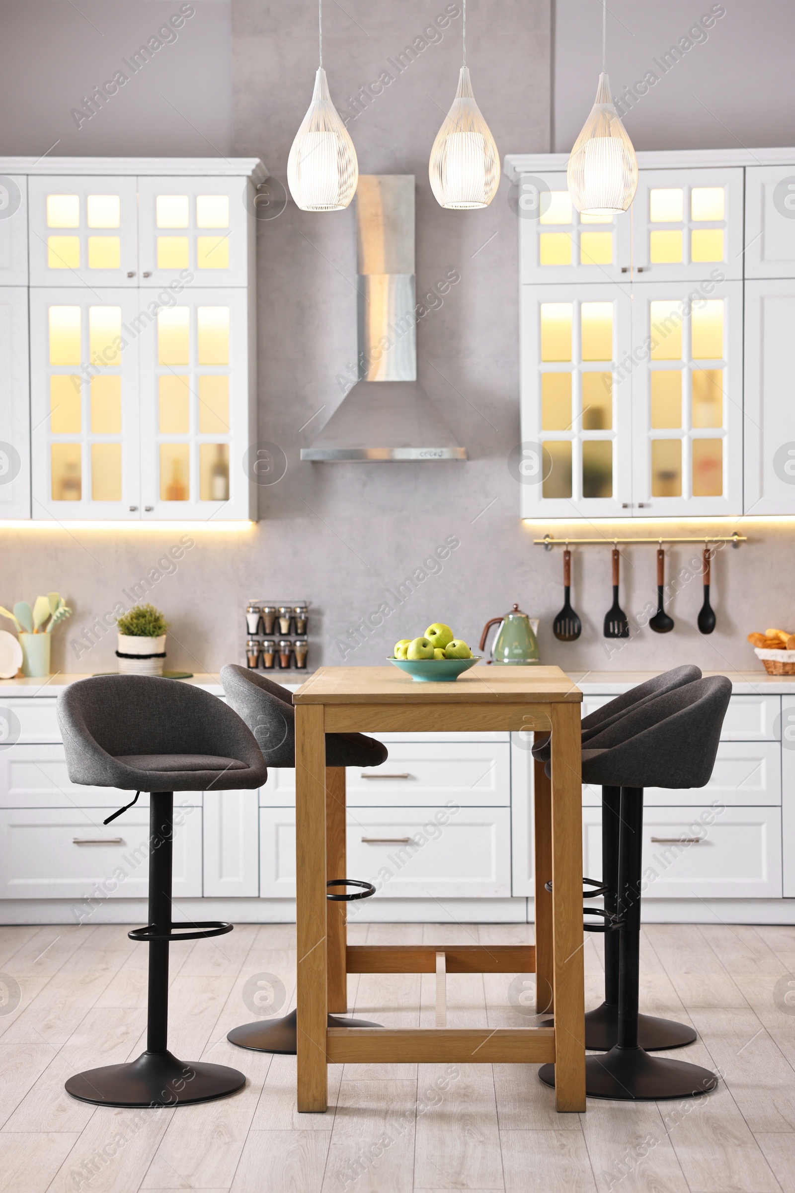 Photo of Bar stools near table in stylish kitchen