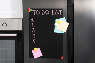 Magnetic board with to do list and notes on refrigerator in kitchen