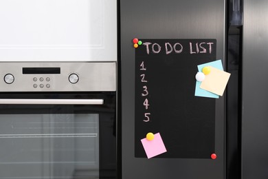 Photo of Magnetic board with to do list and notes on refrigerator in kitchen