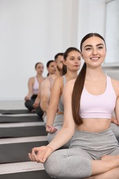 Group of people meditating on mats in yoga class