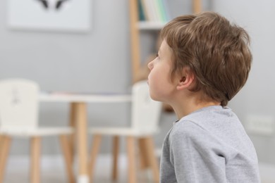 Photo of Autism concept. Lonely little boy at home, space for text