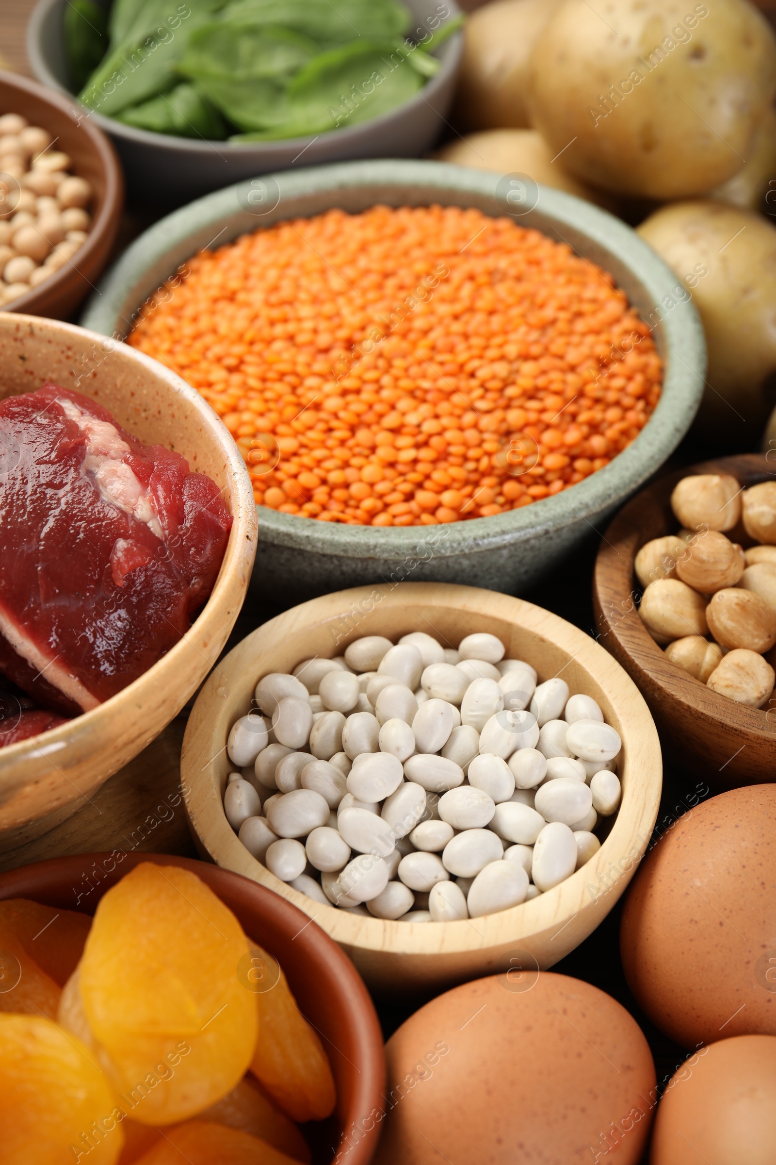 Photo of Different products rich in iron on table, closeup