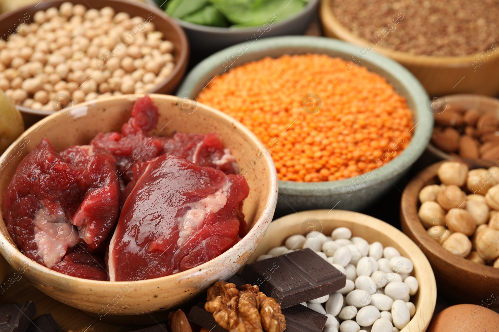 Photo of Different products rich in iron on table, closeup