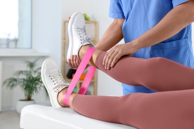 Photo of Physiotherapist working with senior patient in rehabilitation center, closeup