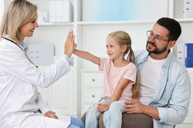 Father and her little daughter having appointment with doctor in hospital