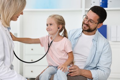 Photo of Father and her little daughter having appointment with doctor in hospital