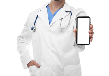 Photo of Doctor showing smartphone with blank screen on white background, closeup. Mockup for design