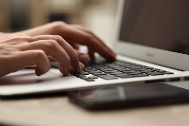 Photo of Businessman using laptop at table, closeup. Modern technology