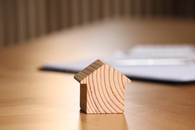 Photo of Property insurance. House figure on wooden table