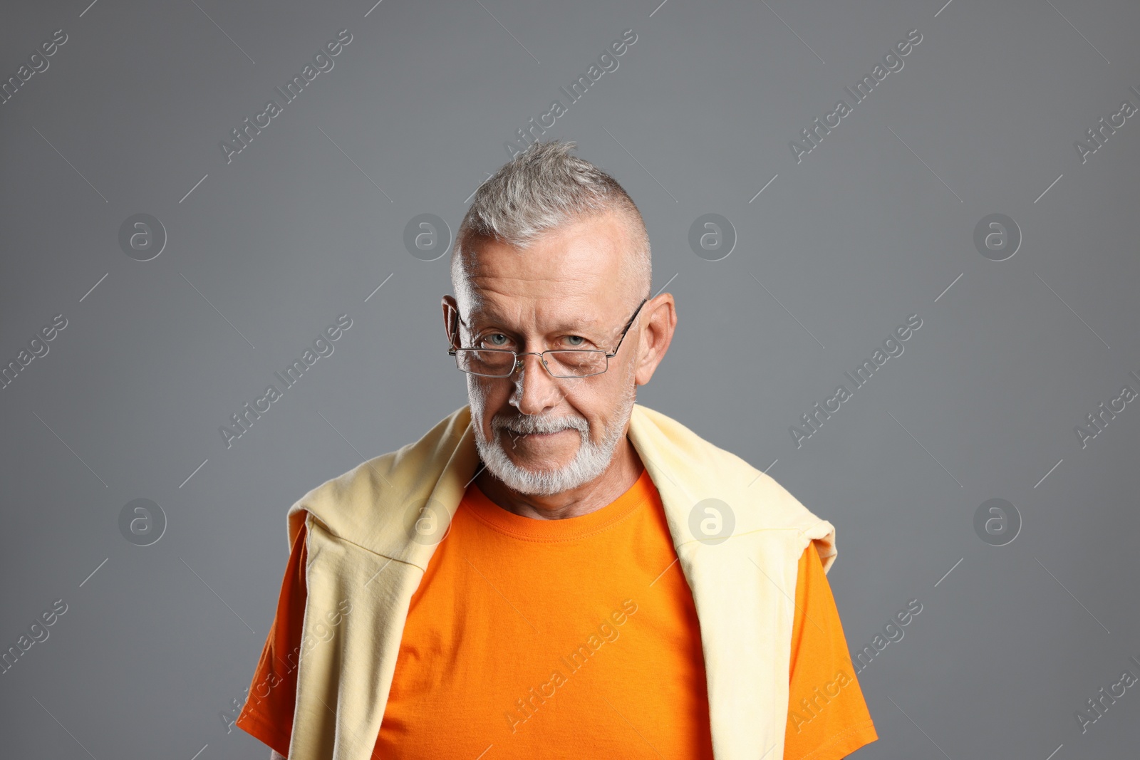 Photo of Portrait of handsome senior man on grey background