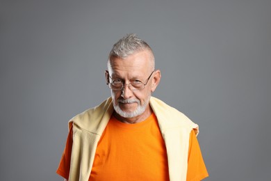 Portrait of handsome senior man on grey background