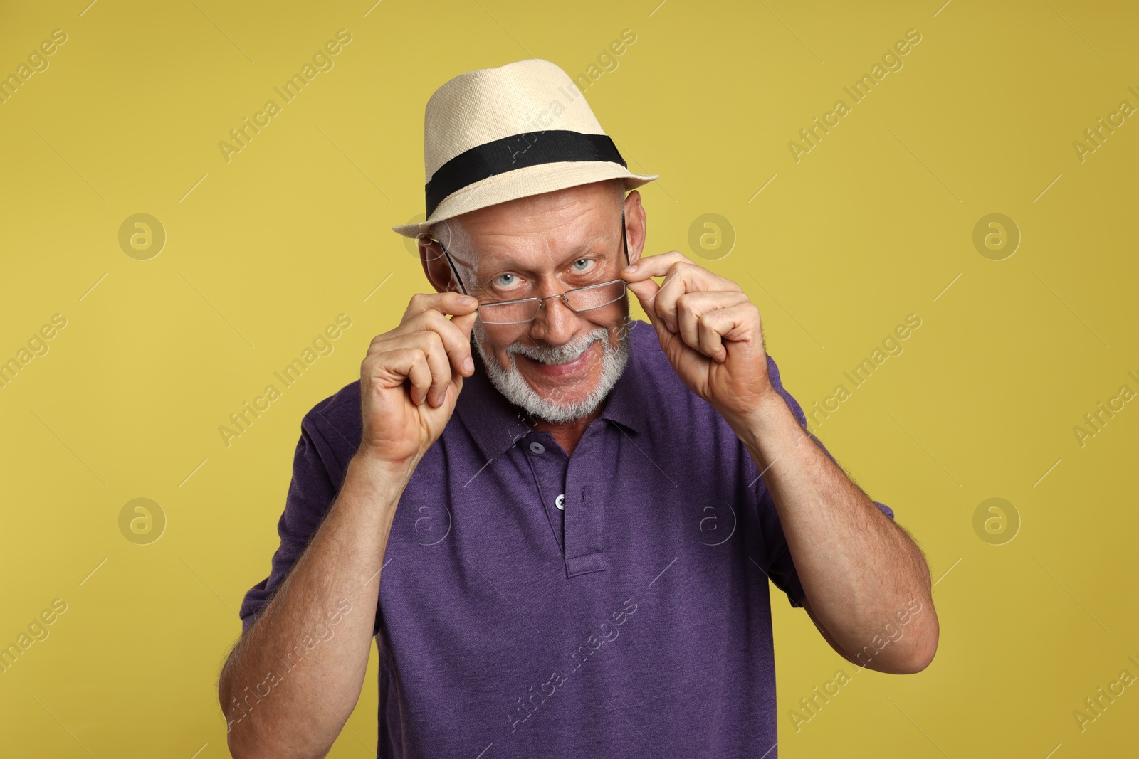 Photo of Portrait of handsome senior man on yellow background