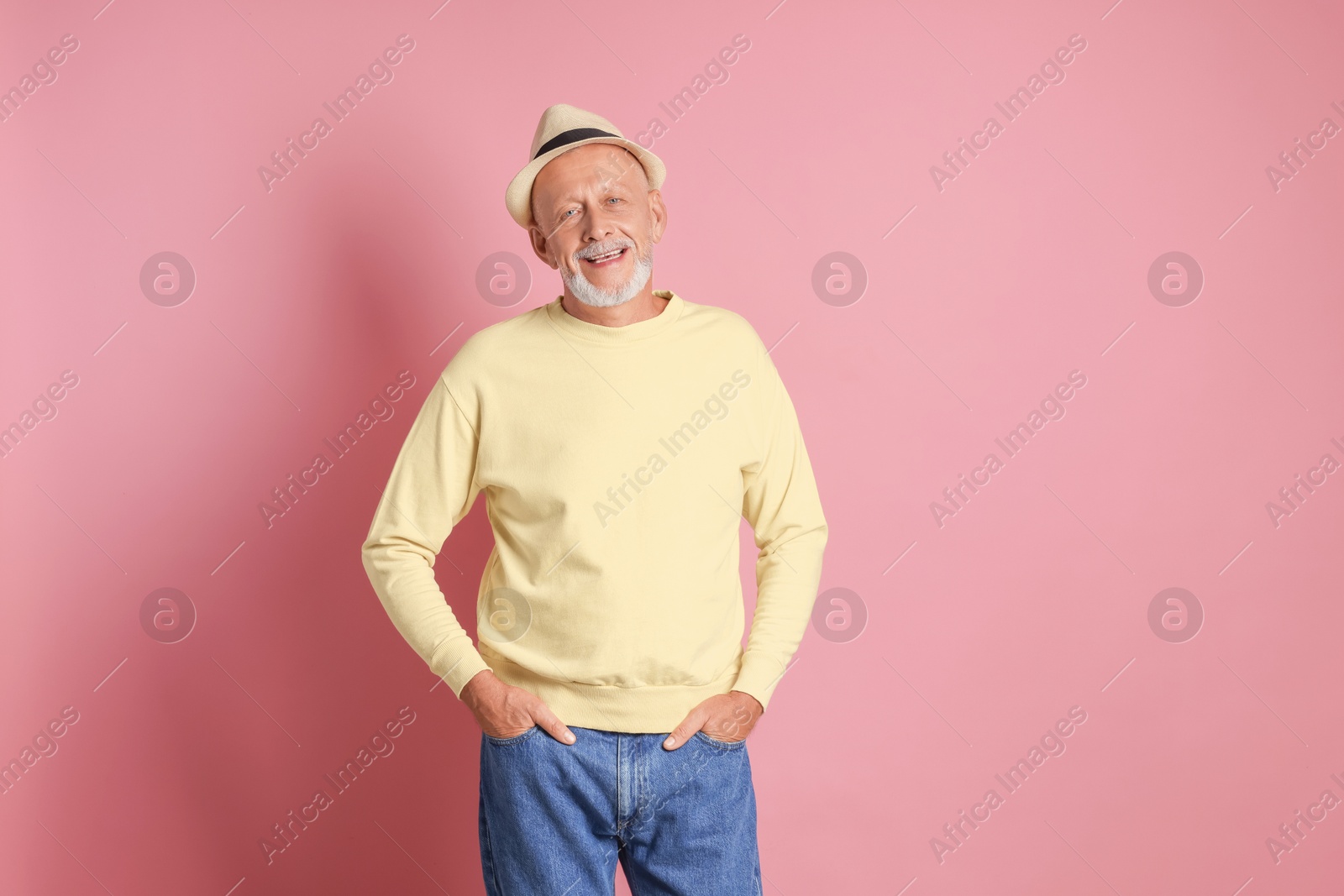 Photo of Portrait of happy senior man on pink background