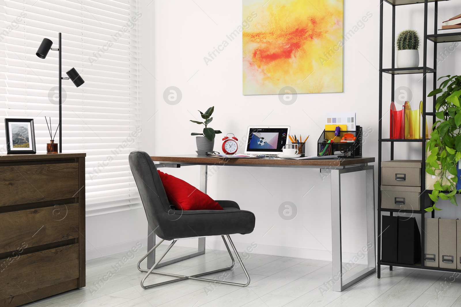 Photo of Fashion designer`s workplace with laptop and different supplies on table