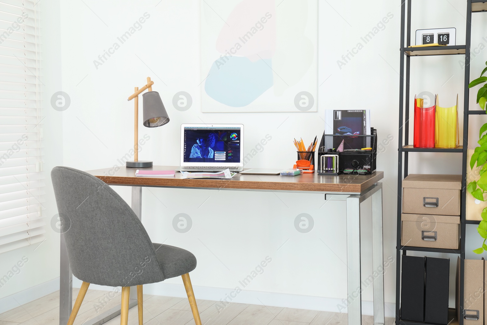 Photo of Fashion designer`s workplace with laptop and different supplies on table