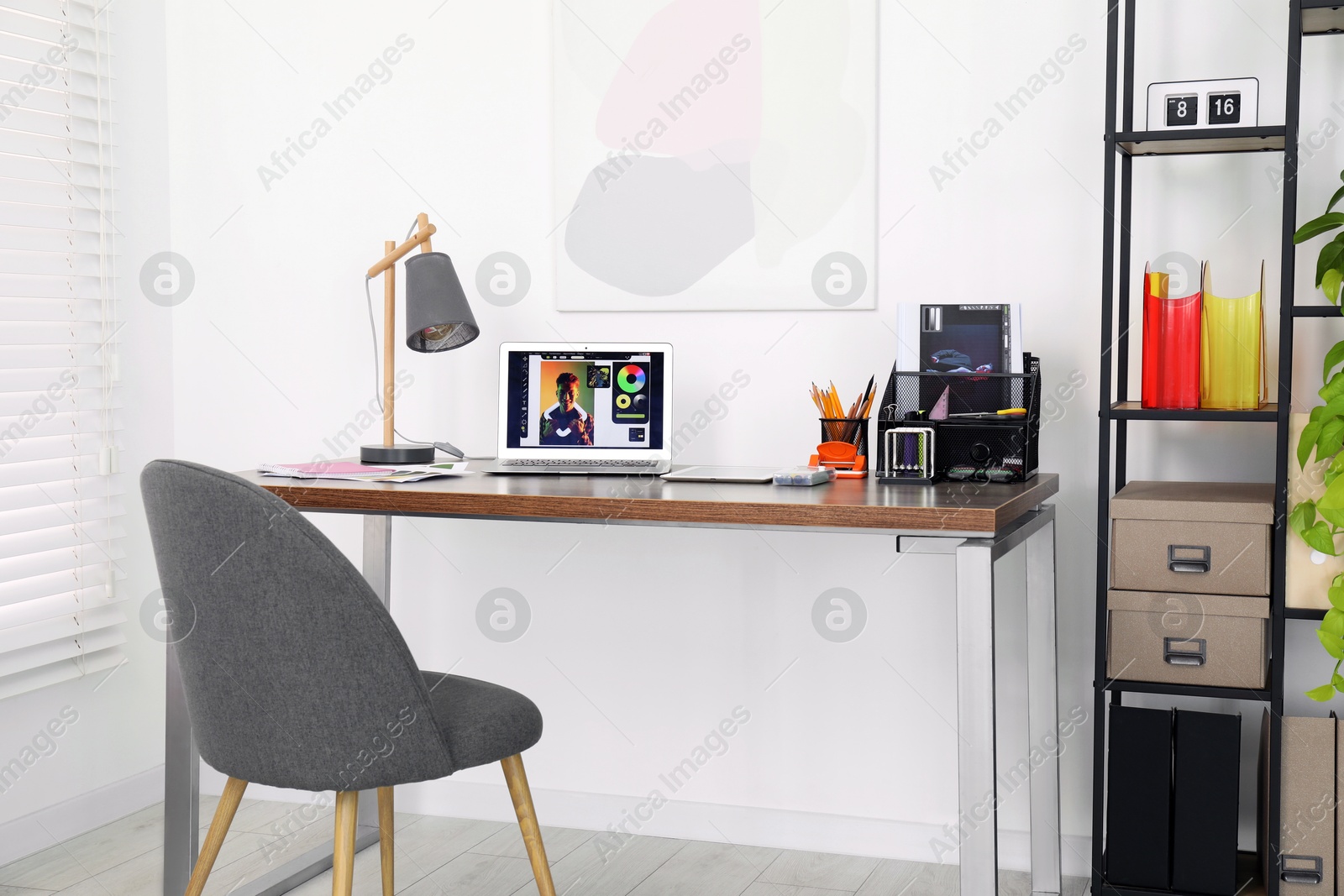 Photo of Fashion designer`s workplace with laptop and different supplies on table