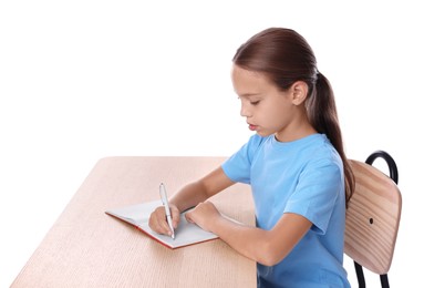 Girl with correct posture and notebook sitting at wooden desk on white background