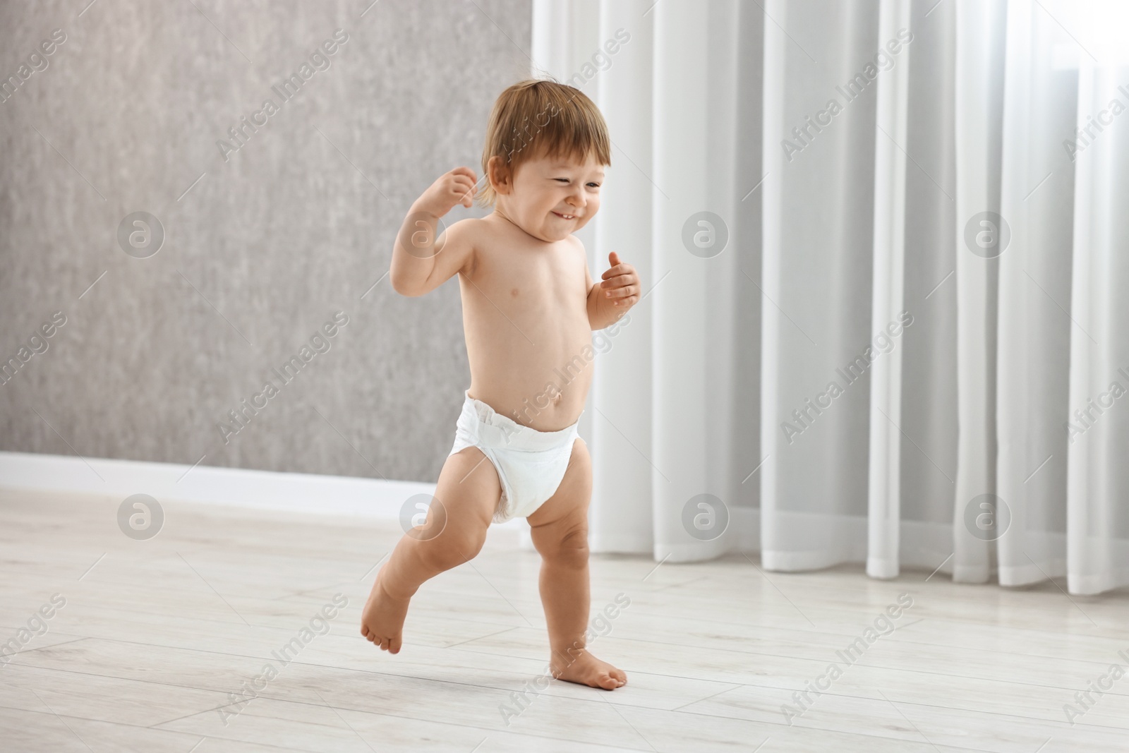 Photo of Cute little child in diaper at home