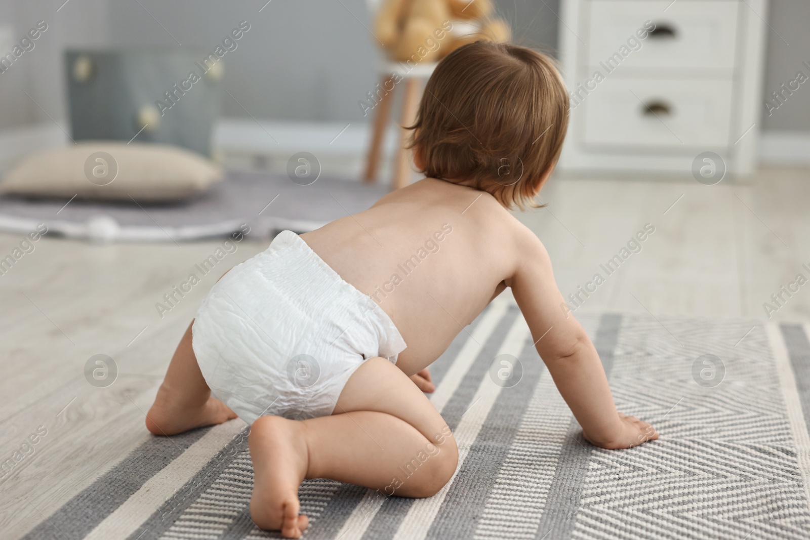 Photo of Cute little child in diaper at home