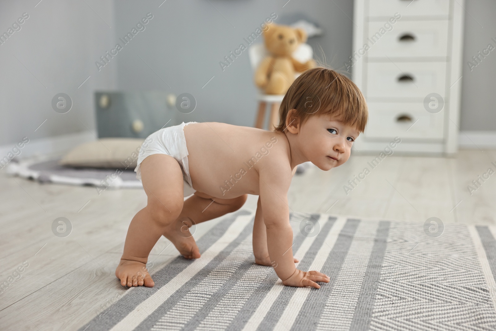 Photo of Cute little child in diaper at home