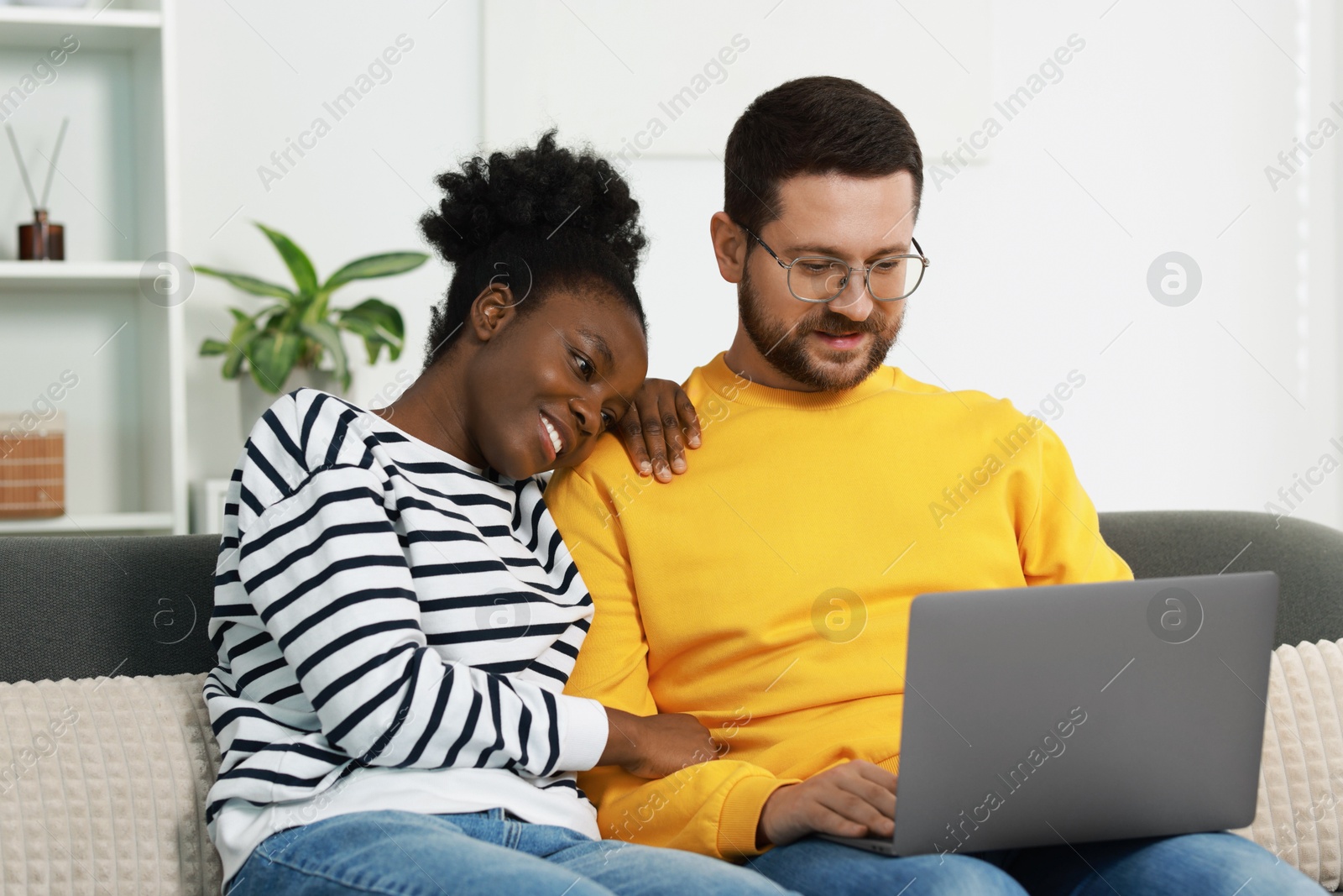 Photo of International relationships. Lovely couple spending time together at home