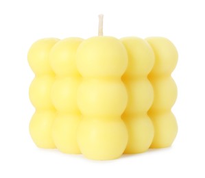 Photo of One yellow bubble candle isolated on white