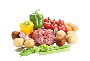 Photo of Cooking stew. Uncooked meat and vegetables isolated on white