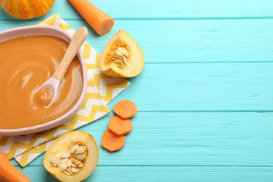 Photo of Delicious baby food in bowl and ingredients on light blue wooden table. Space for text