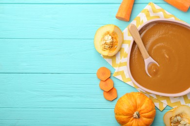 Photo of Delicious baby food in bowl and ingredients on light blue wooden table, flat lay. Space for text