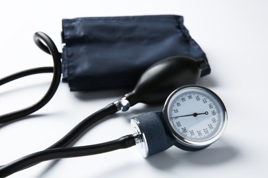 Photo of Blood pressure measuring device on light background, closeup