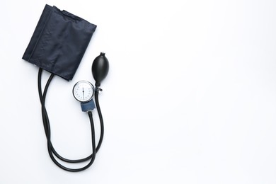 Photo of Blood pressure measuring device on light background, top view. Space for text