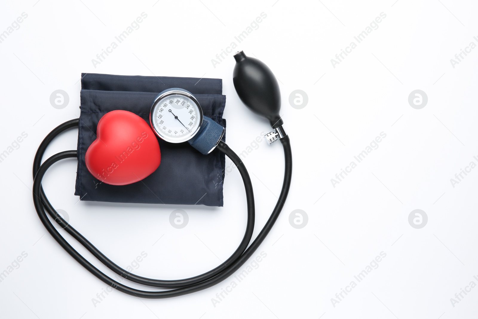 Photo of Blood pressure measuring device and red decorative heart on light background, top view. Space for text