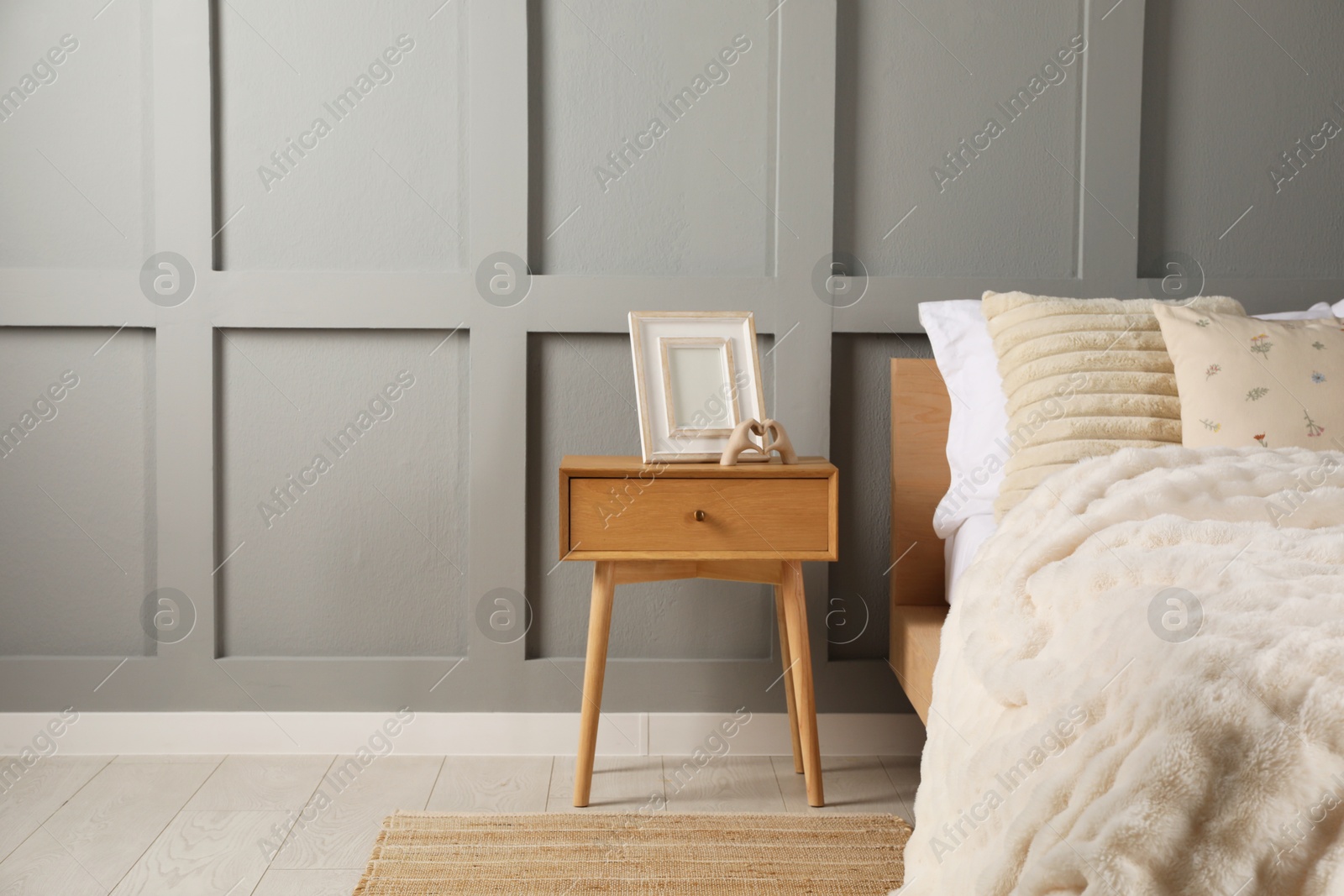 Photo of Bed with beautiful cushions in room, space for text