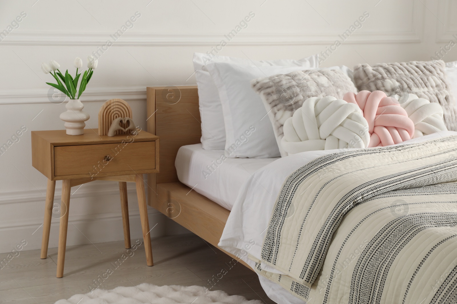 Photo of Bed with beautiful cushions in room. Interior design