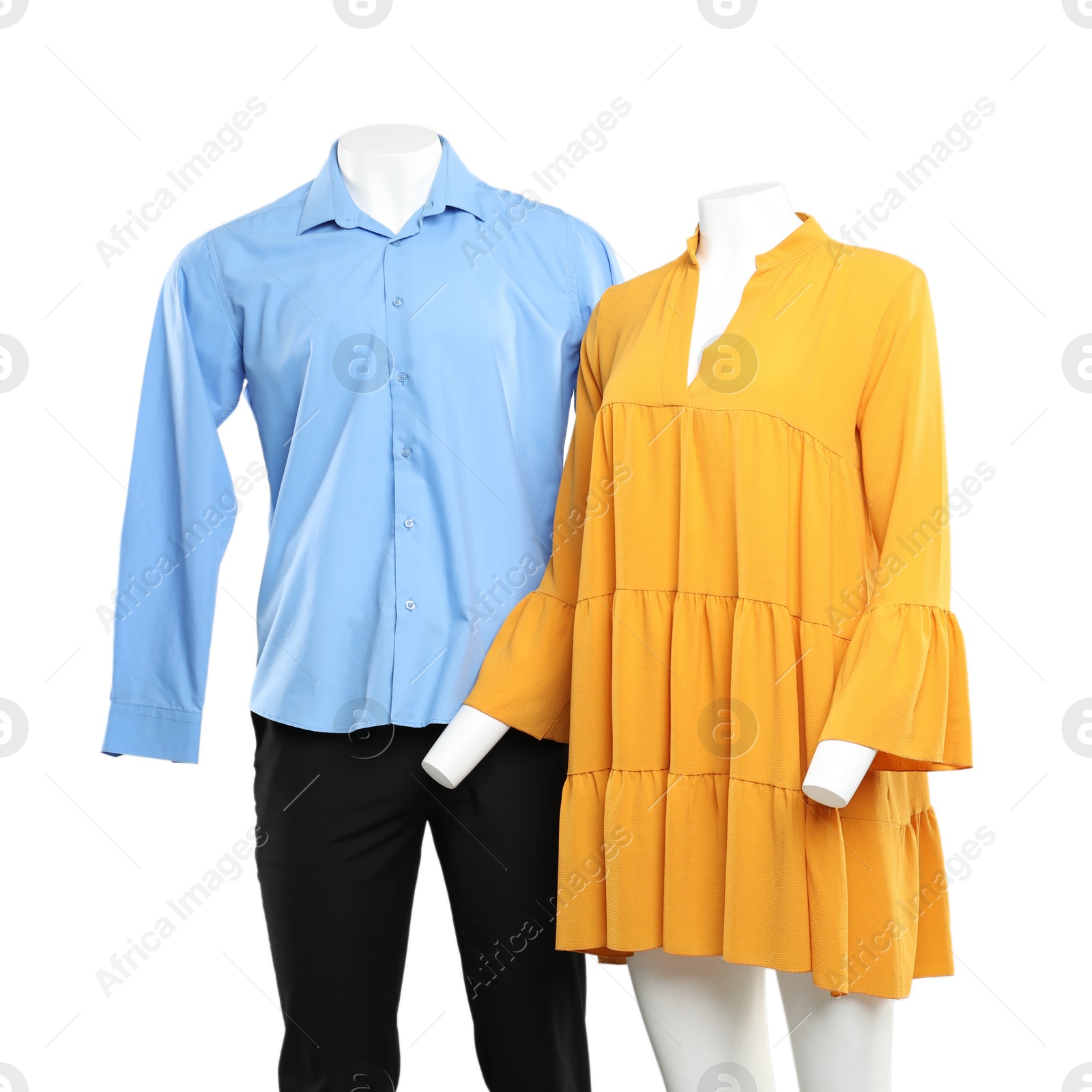 Photo of Female and male mannequins with stylish outfits on light background