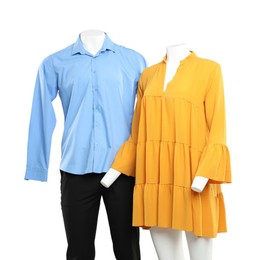 Female and male mannequins with stylish outfits on light background