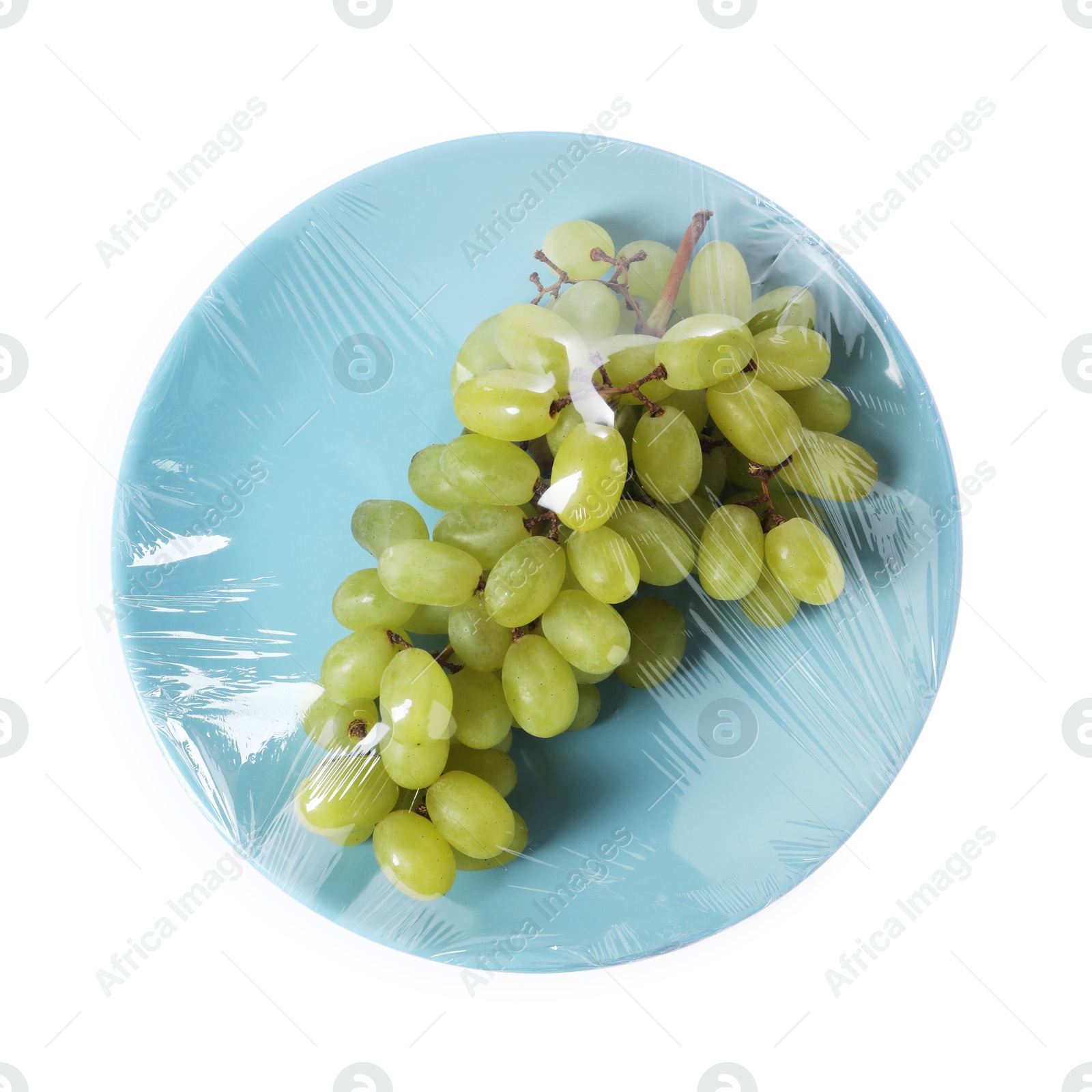 Photo of Plate of fresh grapes with plastic food wrap isolated on white, top view