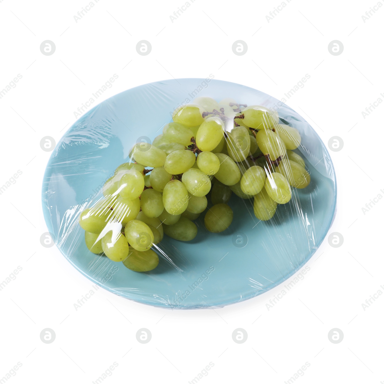 Photo of Plate of fresh grapes with plastic food wrap isolated on white