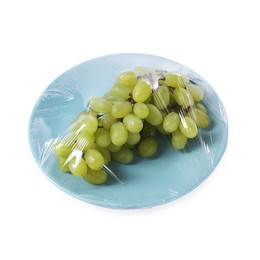 Plate of fresh grapes with plastic food wrap isolated on white