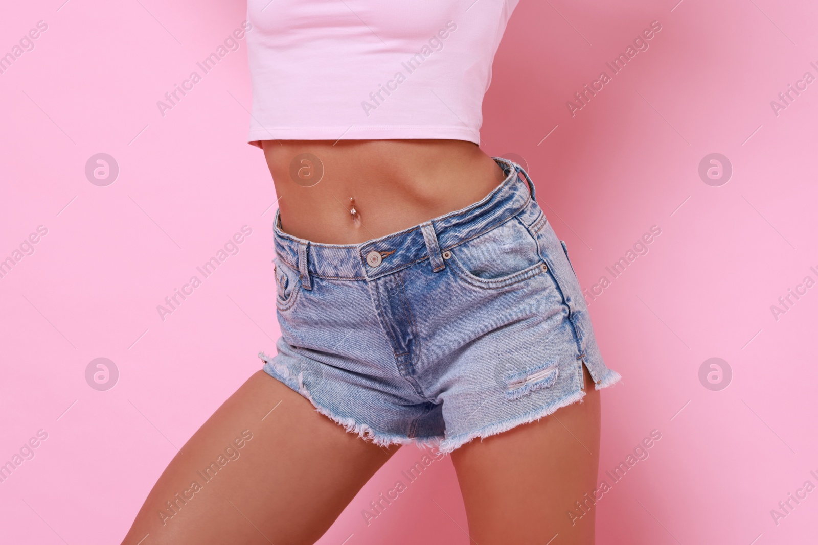 Photo of Woman wearing stylish denim shorts on pink background, closeup