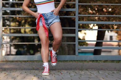 Woman wearing stylish denim shorts outdoors, closeup