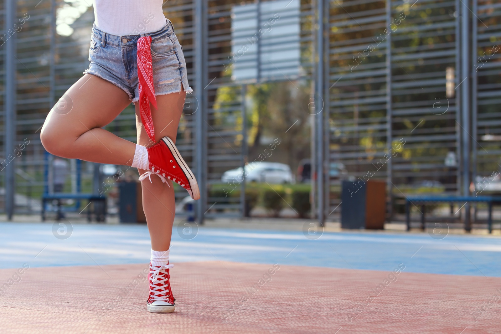 Photo of Woman wearing stylish denim shorts outdoors, closeup. Space for text