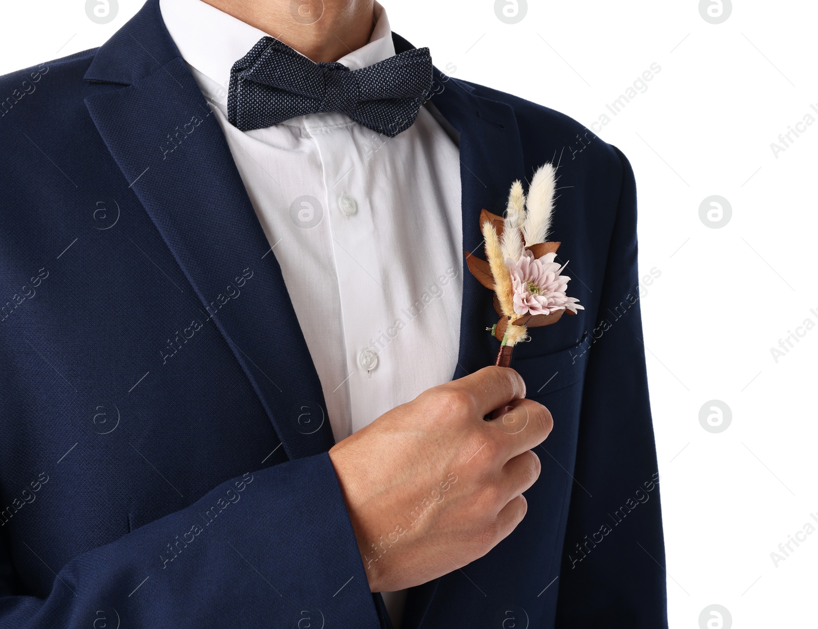 Photo of Groom in suit with stylish boutonniere on white background, closeup