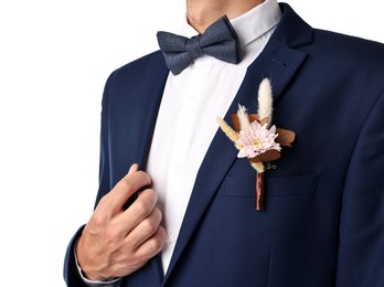 Photo of Groom in suit with stylish boutonniere on white background, closeup