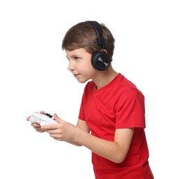 Photo of Cute little boy in headphones playing video game with controller on white background