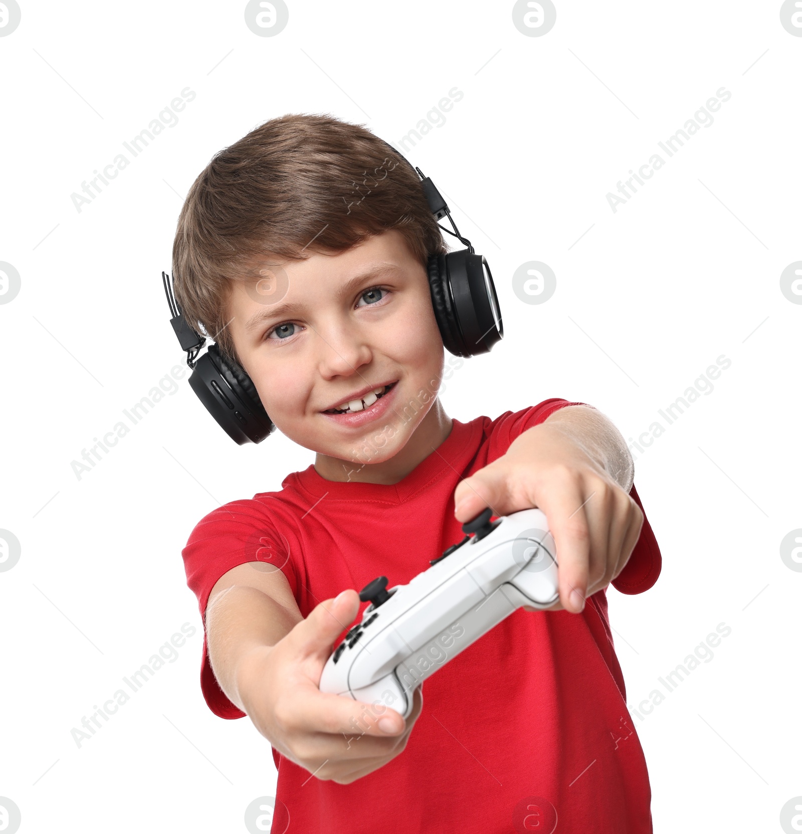 Photo of Happy little boy in headphones playing video game with controller on white background