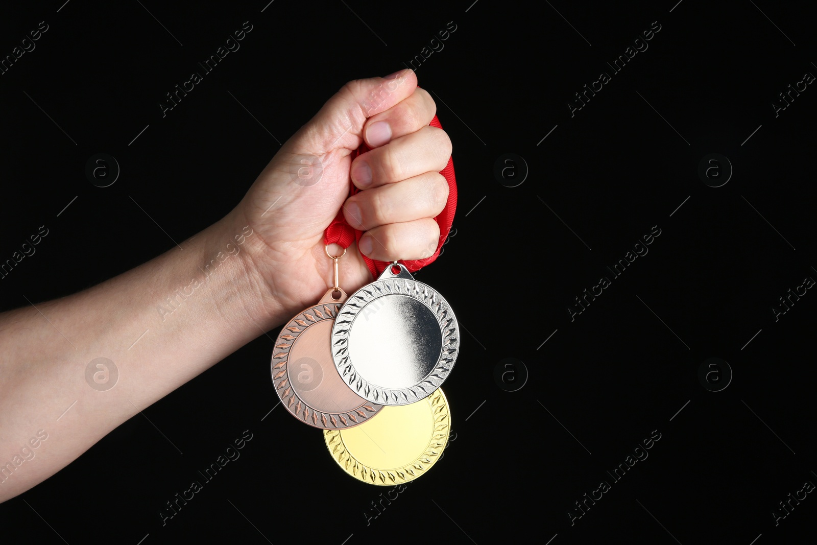 Photo of Man with different medals on black background, closeup