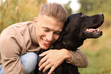 Photo of Portrait of smiling man with cute dog outdoors