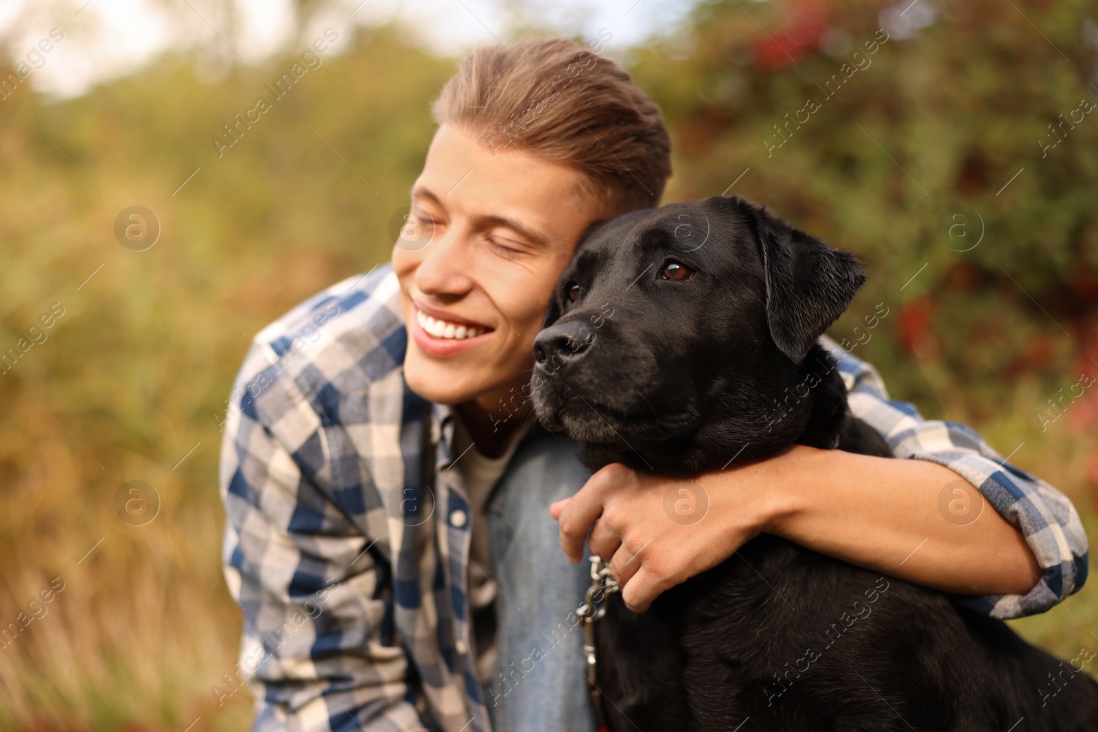 Photo of Smiling man with cute dog outdoors on autumn day